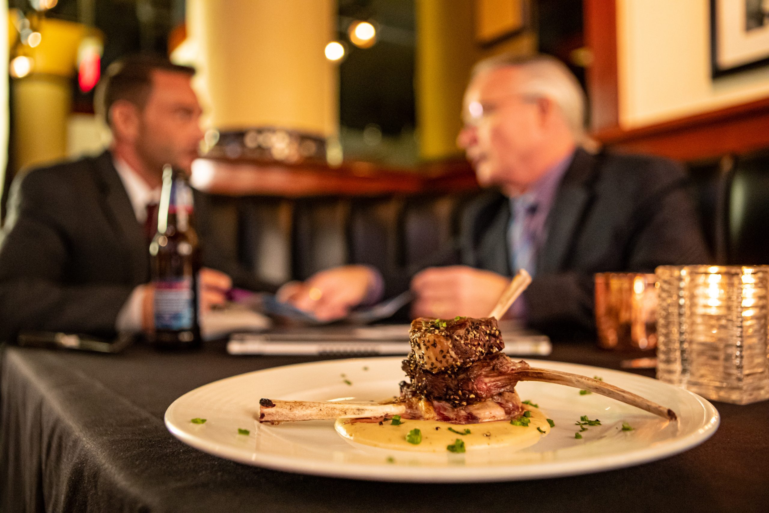 Two Customers Enjoying Wine and Filet at Mickey Mantle's